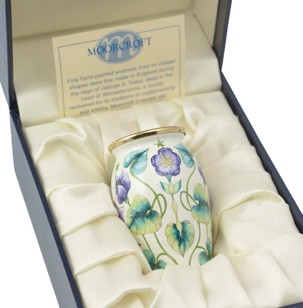 Moorcroft Enamels miniature vase front view showing purple sweet pea flowers and turquoise foliage on pale ground, 2000