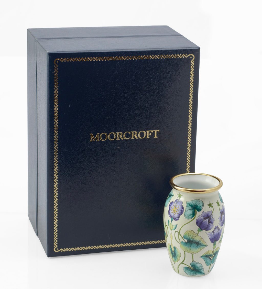 Moorcroft Enamels miniature vase side view showing scrolling stems and broad leaves in turquoise and yellow, 2000