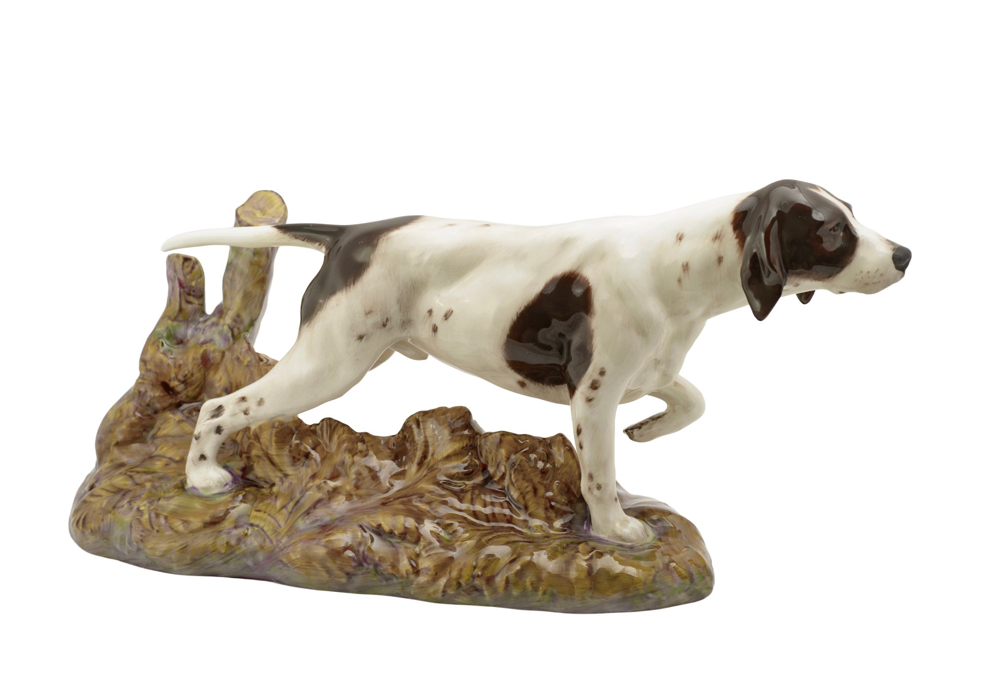 Royal Doulton Pointer dog figure HN2624 - left side profile showing pointing stance with raised foreleg and extended head on naturalistic woodland base