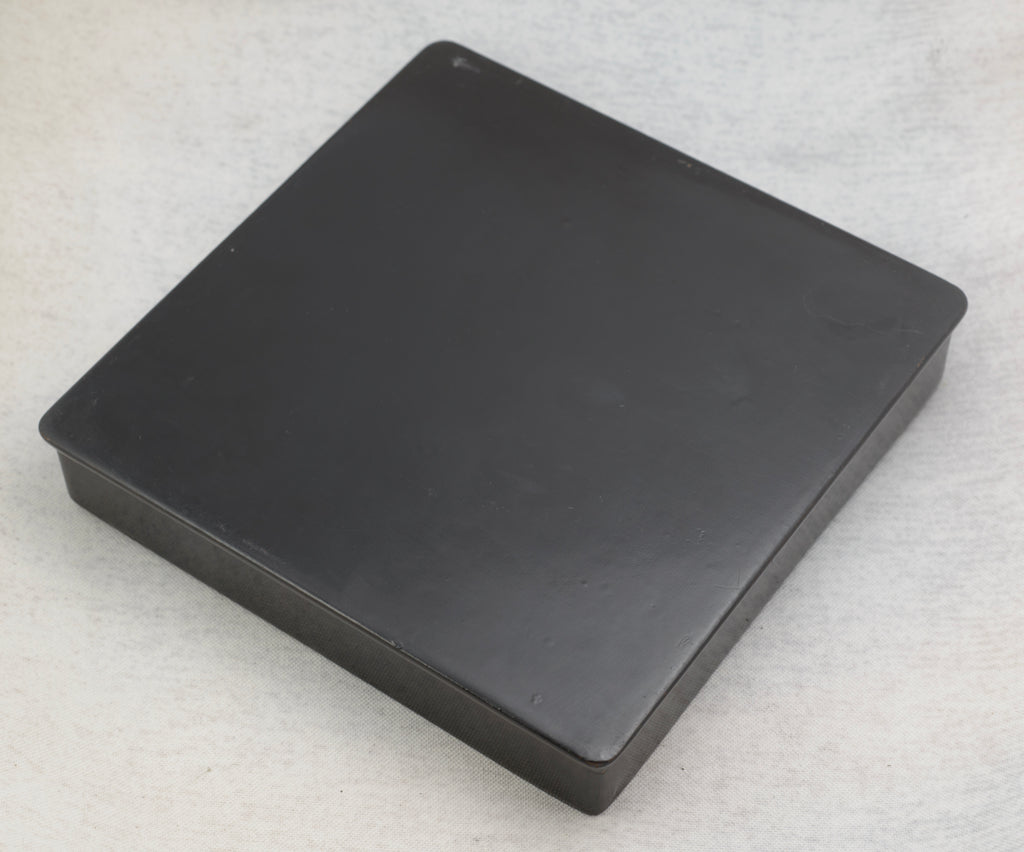 Detailed view of the painted white daisies, foliage and smaller flowers on the glossy black lacquer box
