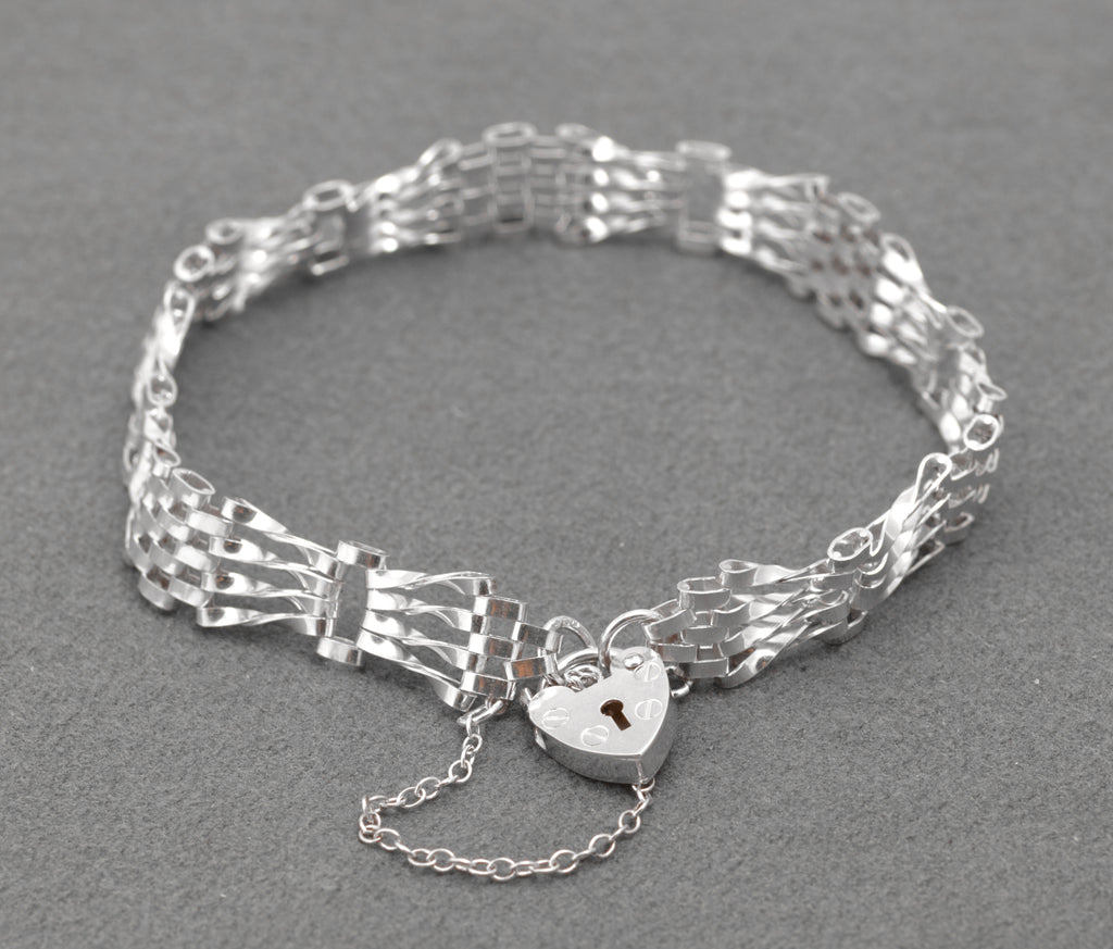 Vintage Sterling Silver Gate Bracelet - full view with heart padlock clasp and safety chain on grey background