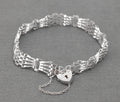 Vintage Sterling Silver Gate Bracelet - full view with heart padlock clasp and safety chain on grey background