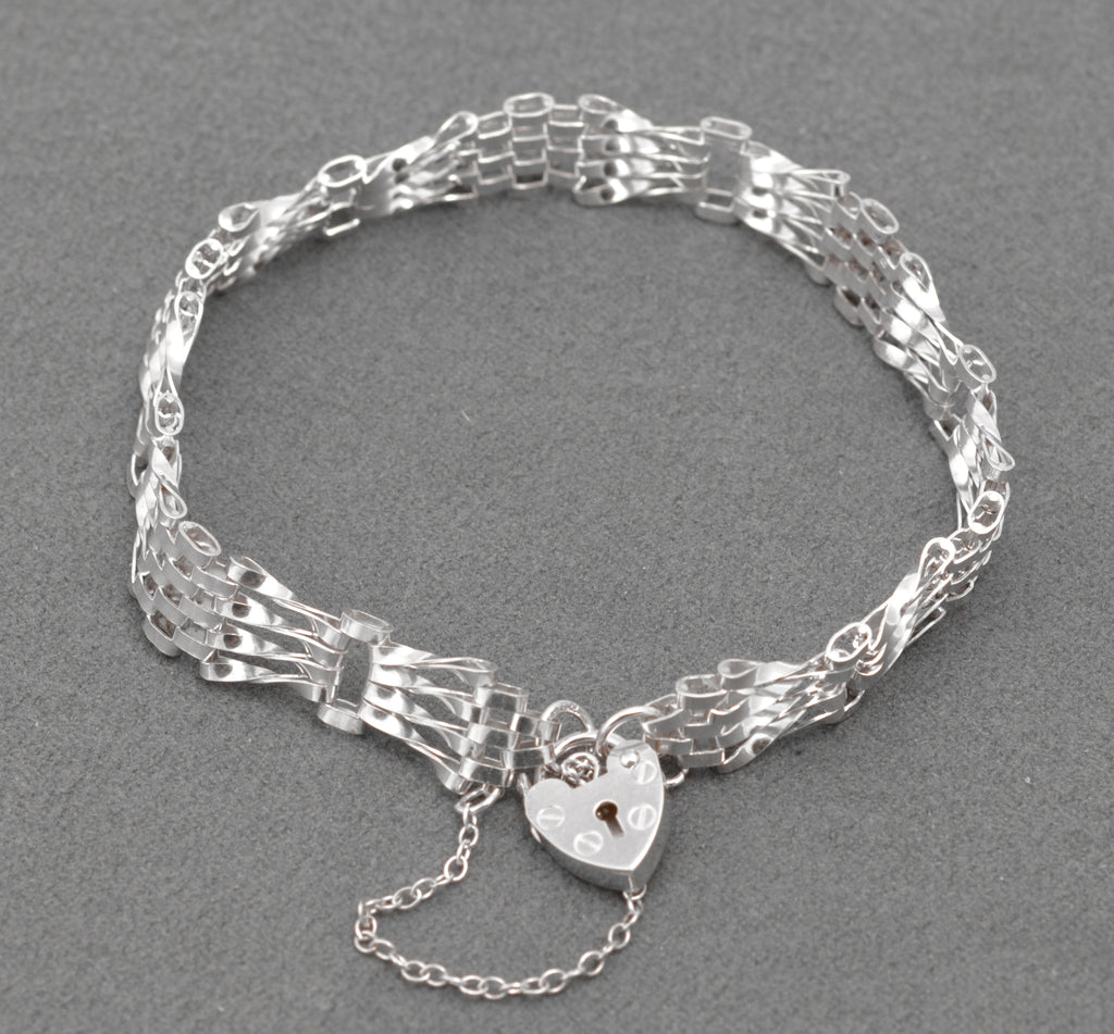Vintage Sterling Silver Gate Bracelet - alternative full view showing twisted gate link profile on grey background