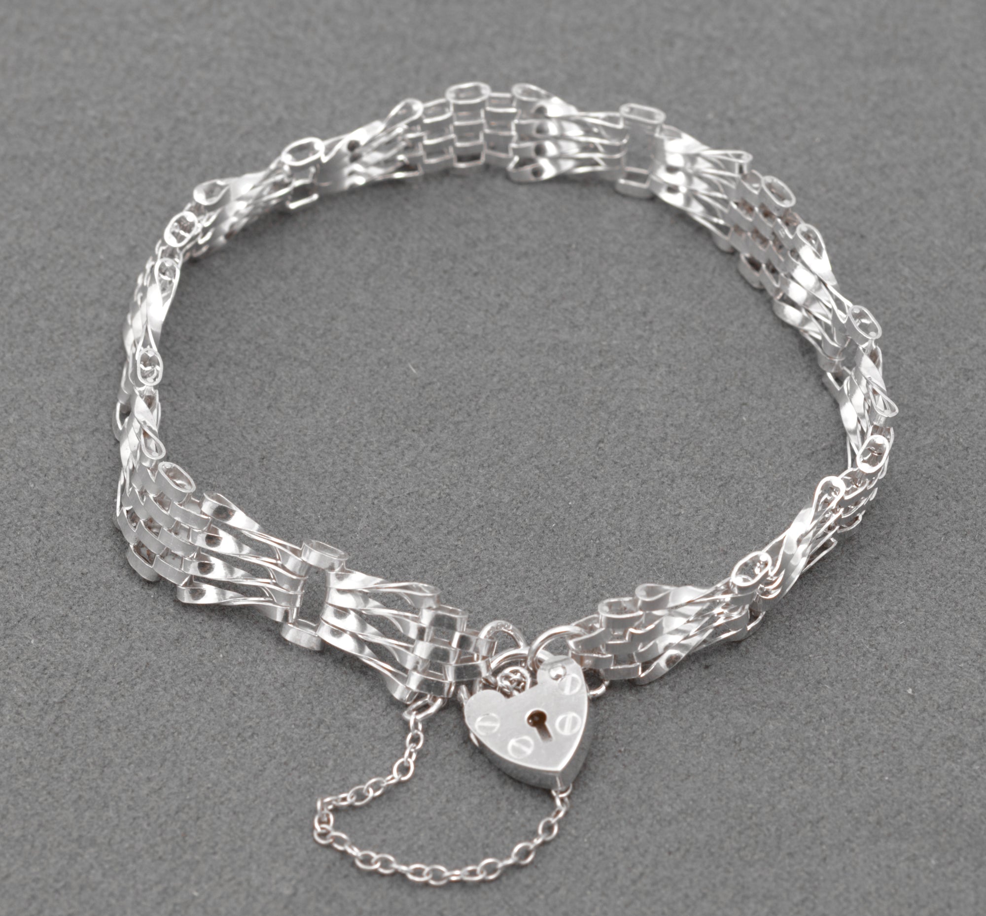 Vintage Sterling Silver Gate Bracelet - alternative full view showing twisted gate link profile on grey background