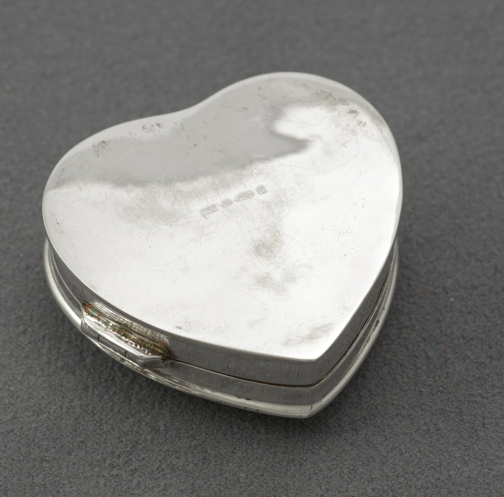 Vintage sterling silver heart shaped trinket box - close-up of engraved scrolling leaf and feather detail on lid