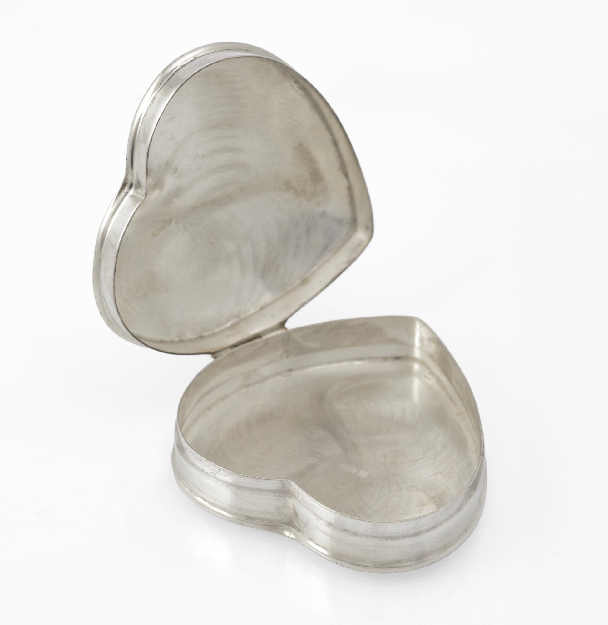 Vintage sterling silver heart shaped trinket box - front view showing heart form and engraved foliate lid with dotted border
