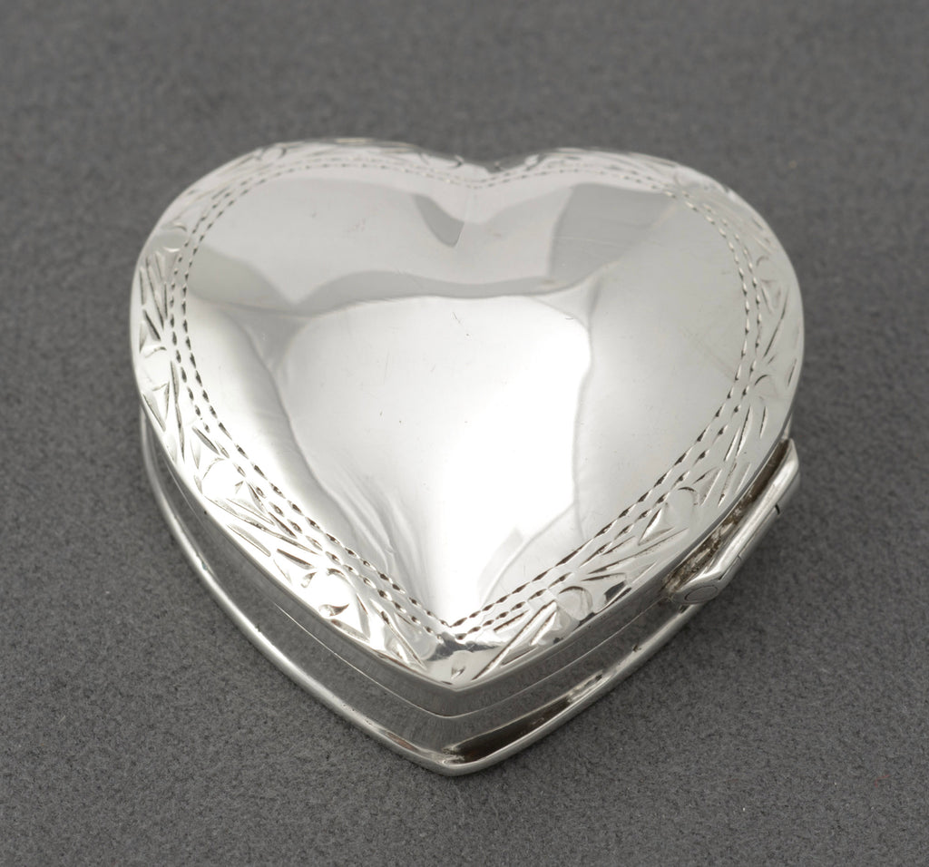 Vintage sterling silver heart shaped trinket box closed showing plain polished lid with engraved border, London 1993