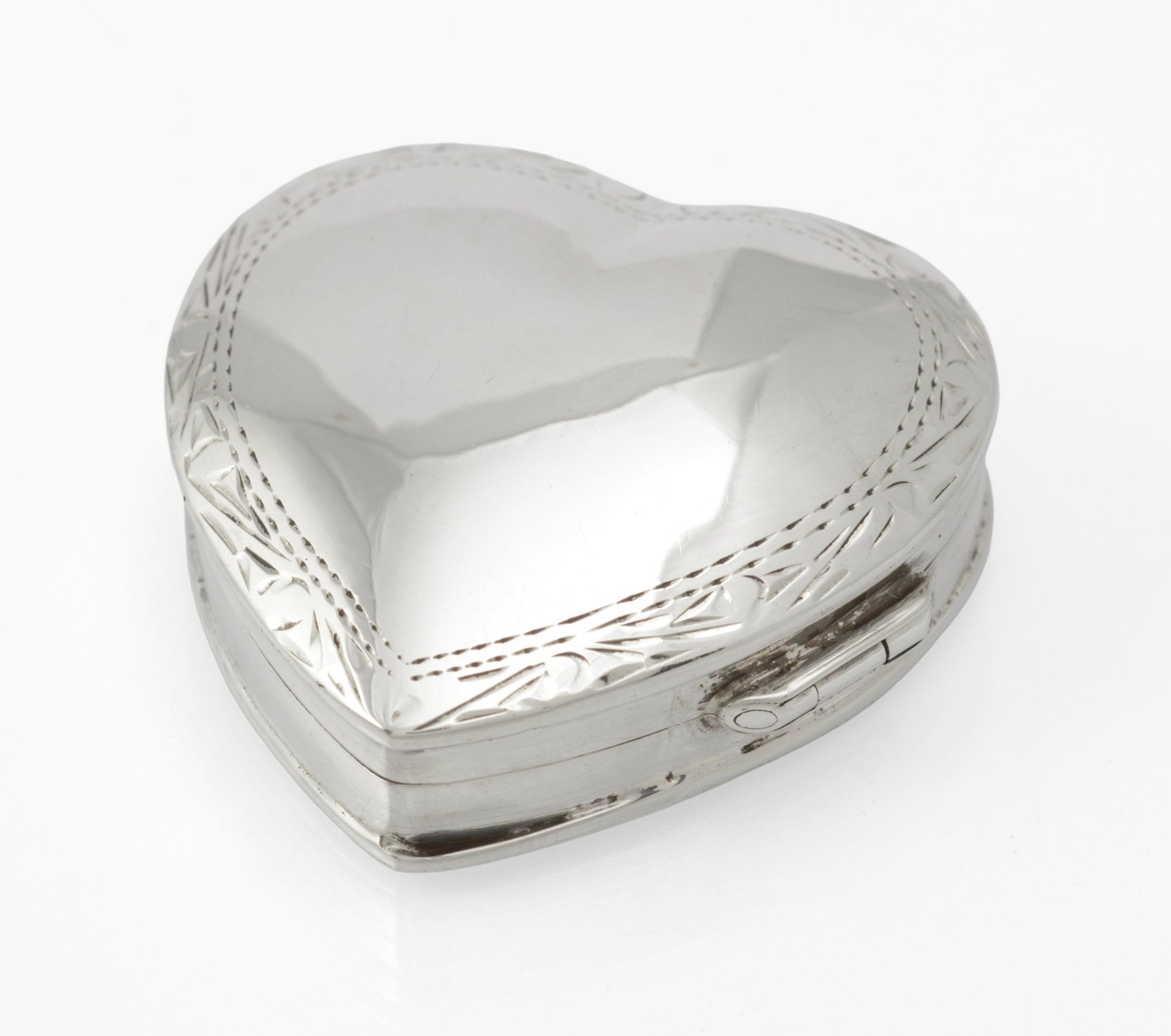 Vintage sterling silver heart shaped trinket box - front view closed showing heart form and engraved decoration