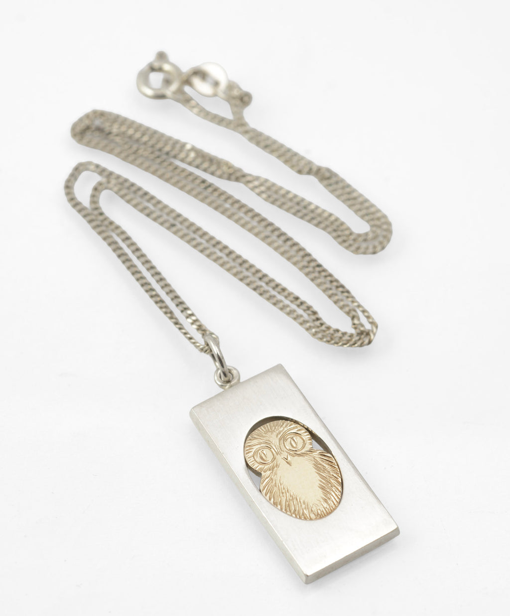 Vintage Finnish sterling silver owl pendant - close-up of owl face showing finely worked feathering and prominent circular eyes