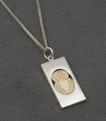 Vintage Finnish sterling silver owl pendant - angled view showing oval owl set within rectangular silver frame