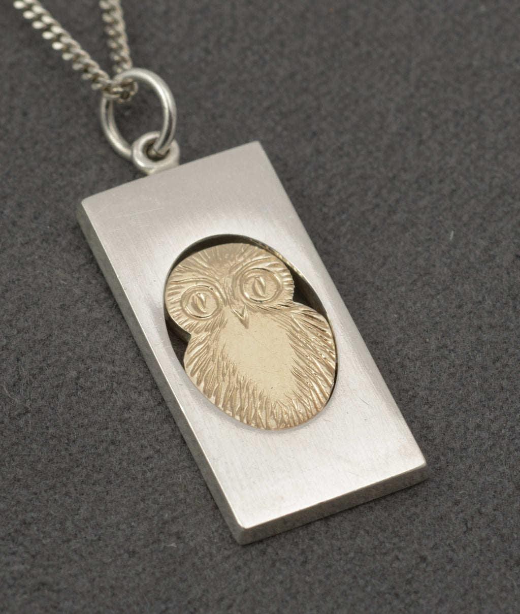 Vintage Finnish sterling silver owl pendant necklace - full pendant and chain on grey background