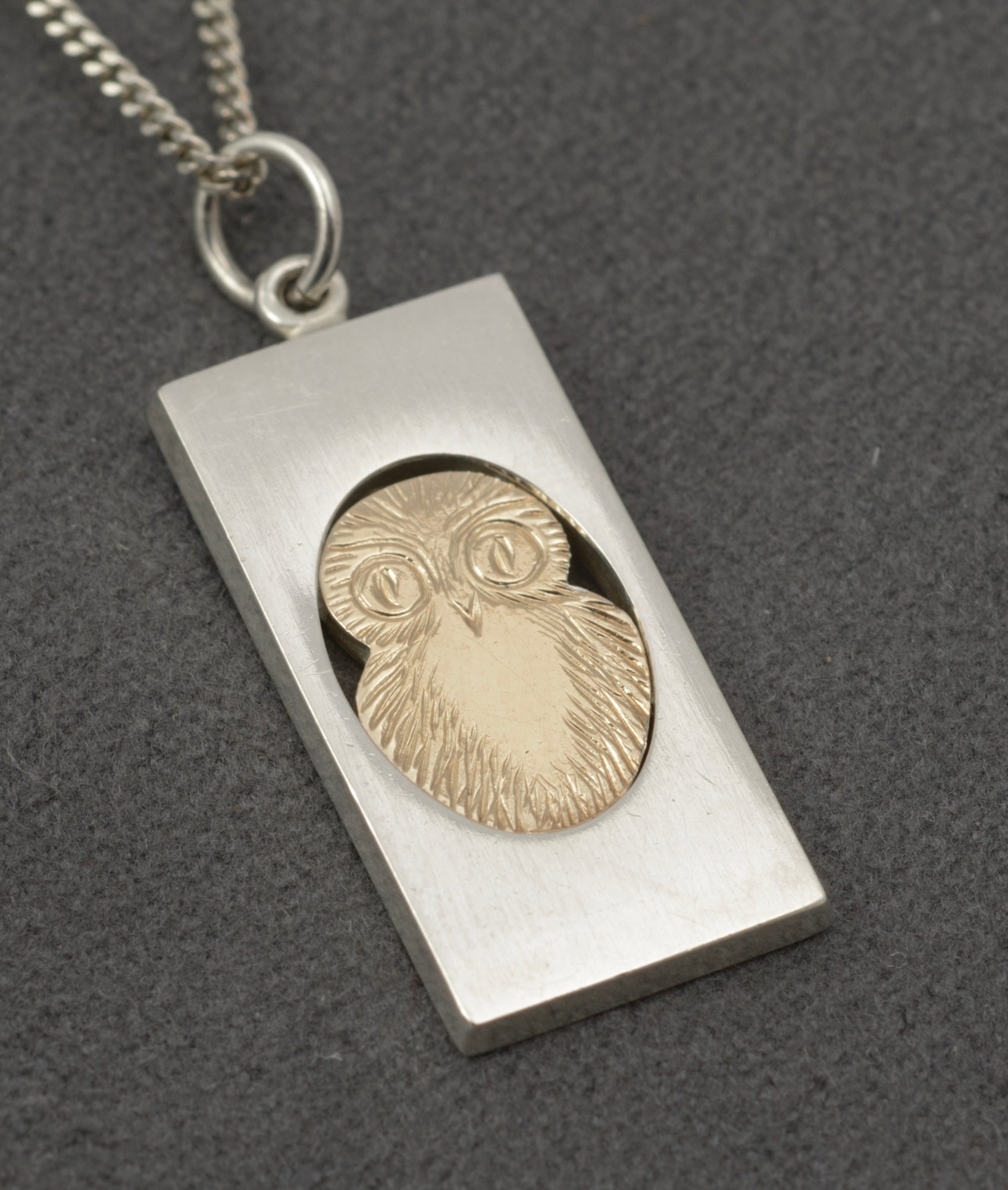Vintage Finnish sterling silver owl pendant necklace - full pendant and chain on grey background