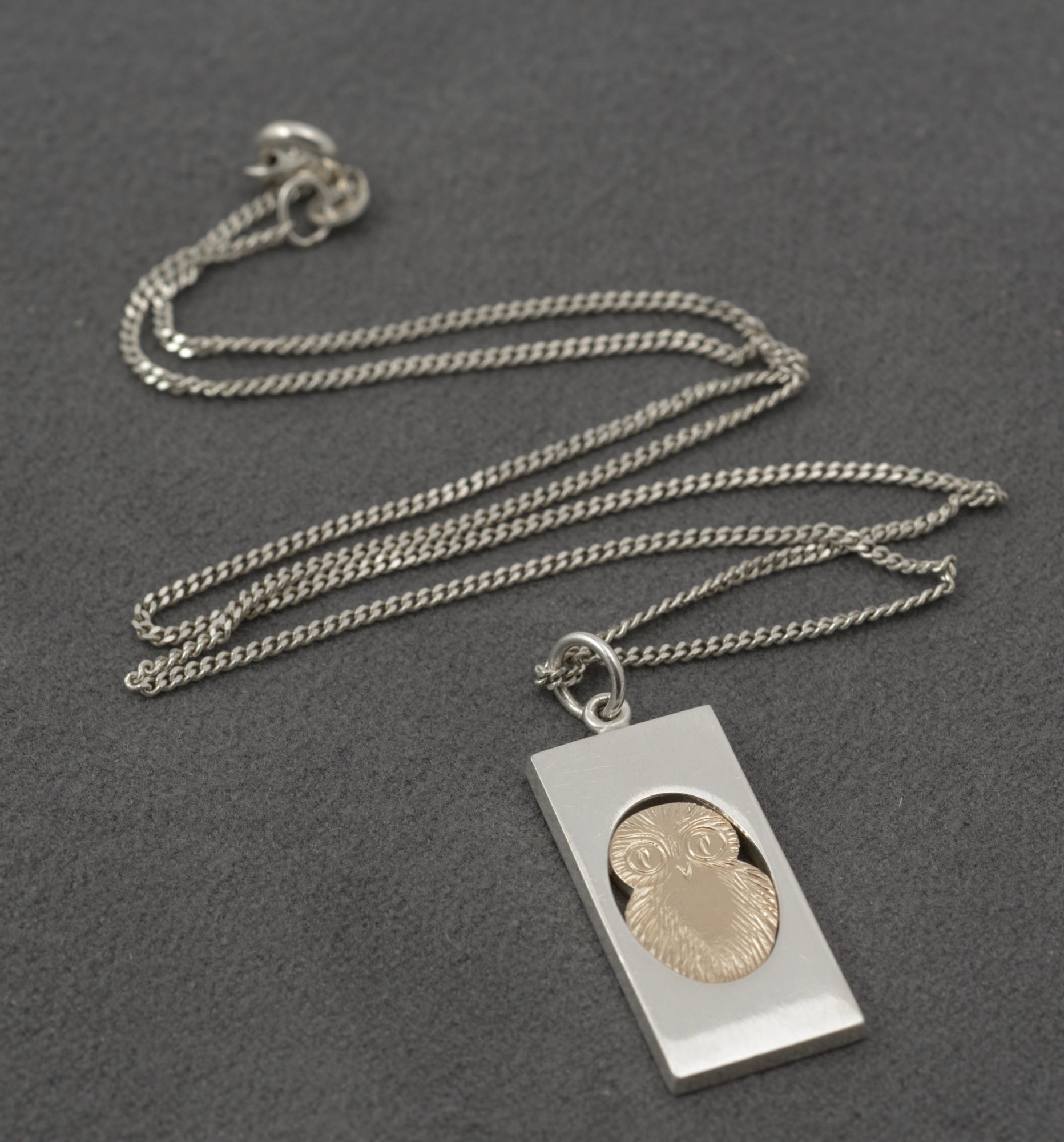 Vintage Finnish sterling silver owl pendant - reverse showing plain back of oval owl visible through open frame and NB 925S hallmark