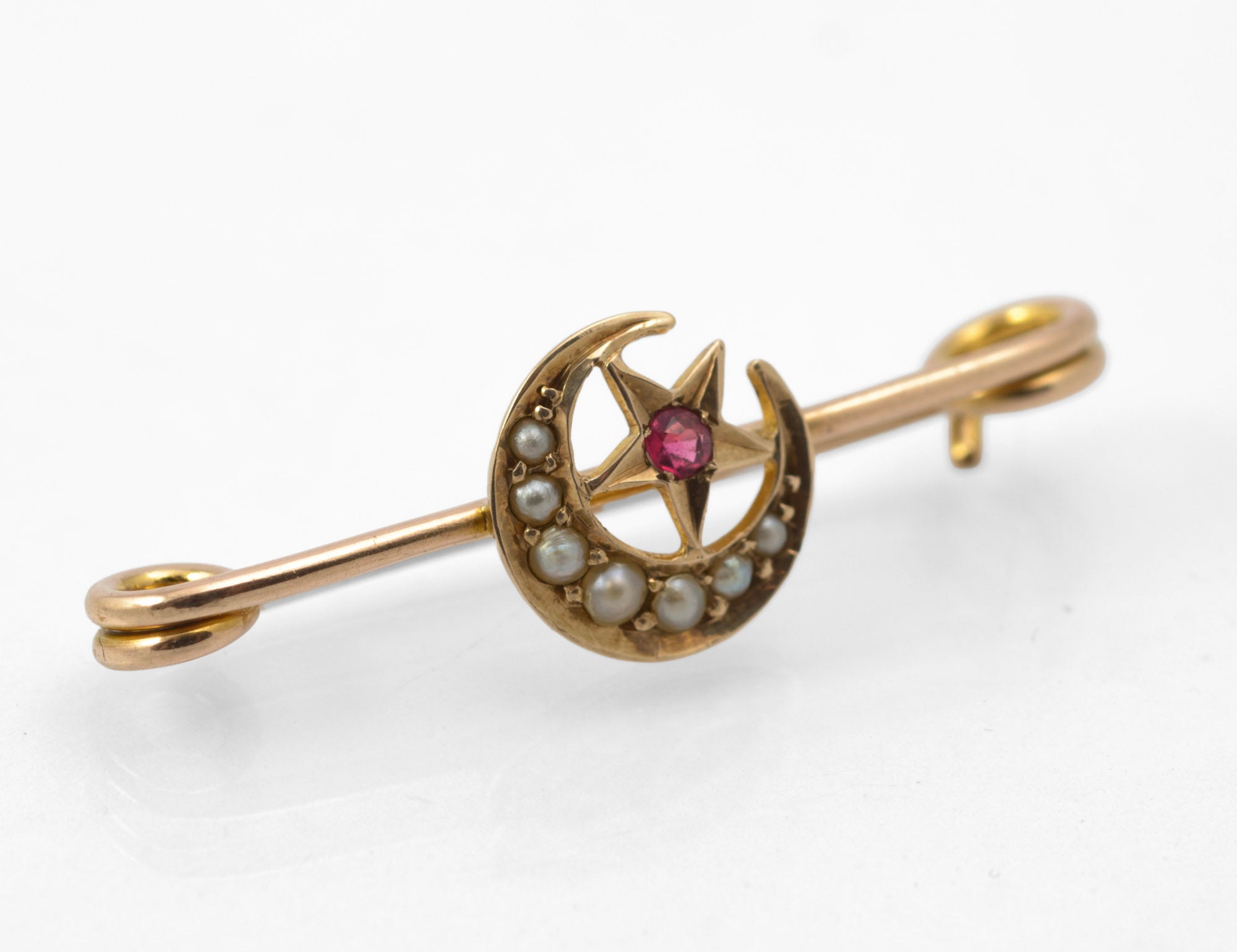 Antique Victorian 9ct gold honeymoon brooch - crescent moon with split pearls and five-pointed star set with red paste stone, front view