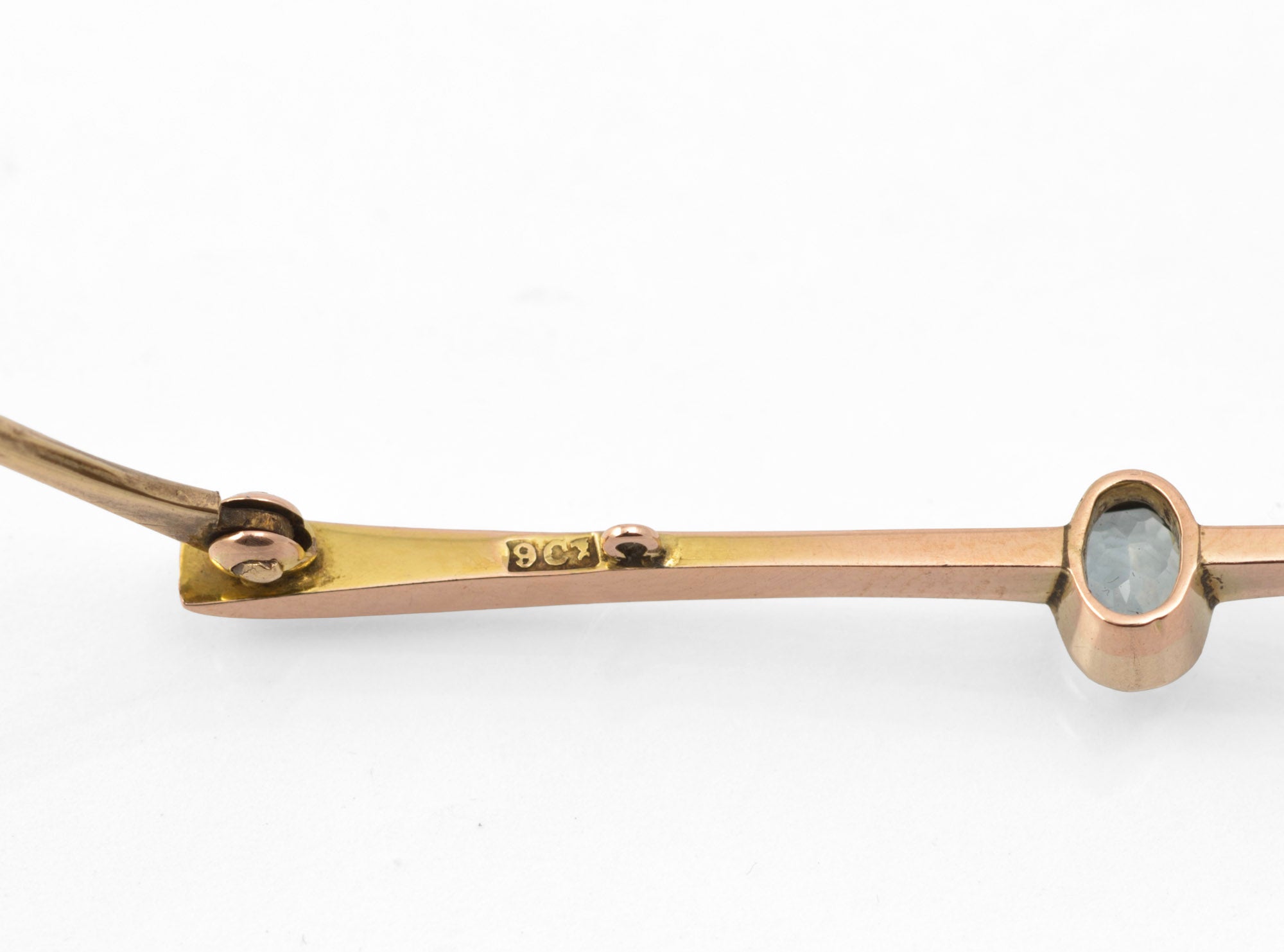 Art Deco 9ct rose gold aquamarine bar brooch - scale reference showing brooch beside a five pence coin