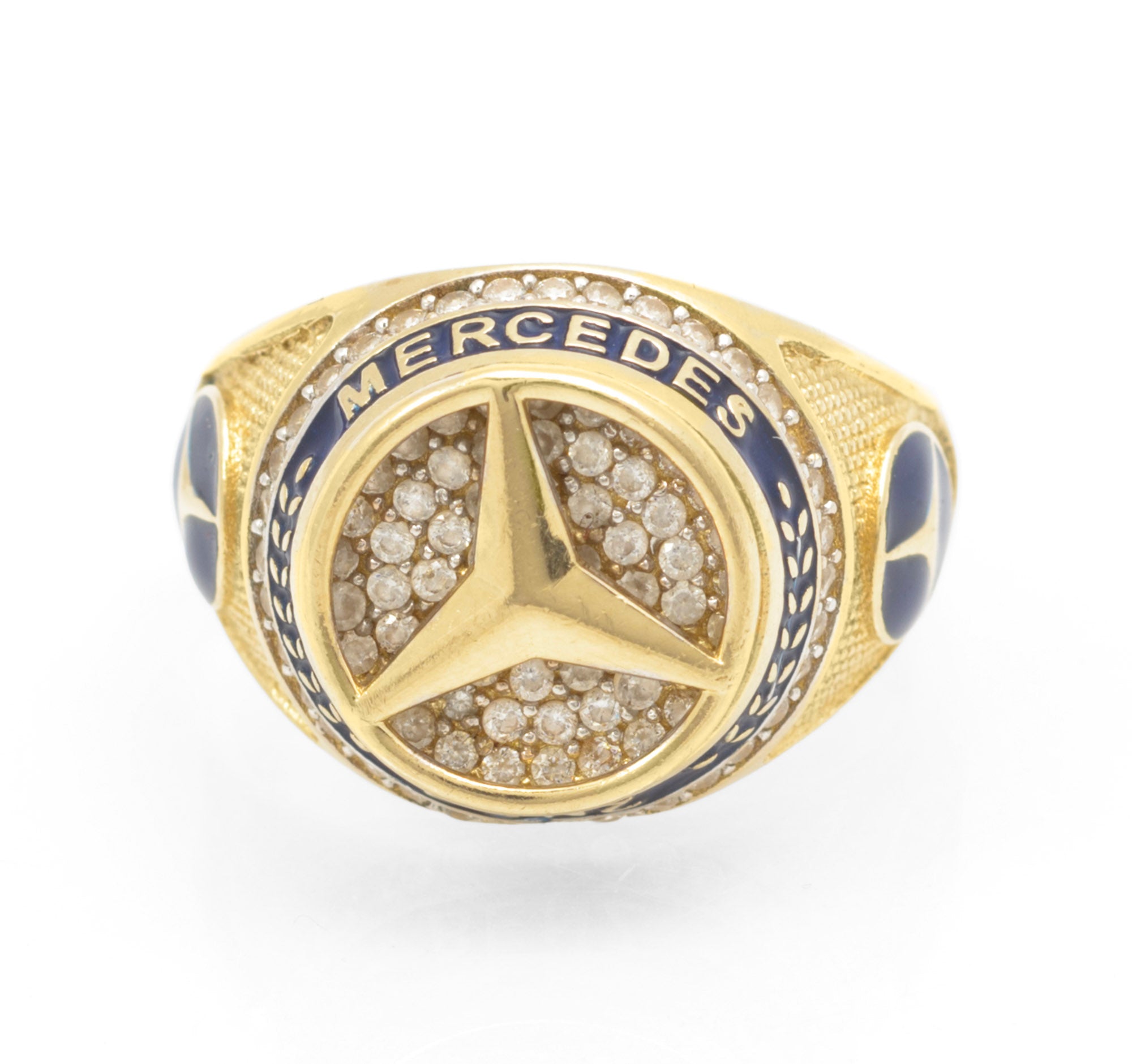 14ct gold Mercedes-Benz motorsport ring - front view showing pave CZ three-pointed star on circular head with blue enamel band reading MERCEDES BENZ and blue enamel star panels to shoulders