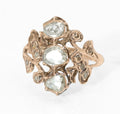 Georgian gold and diamond cluster ring - three-quarter front view showing portrait cut centre diamond with rose cut north and south stones and mixed mine and rose cut surround in open scrolling gold mount