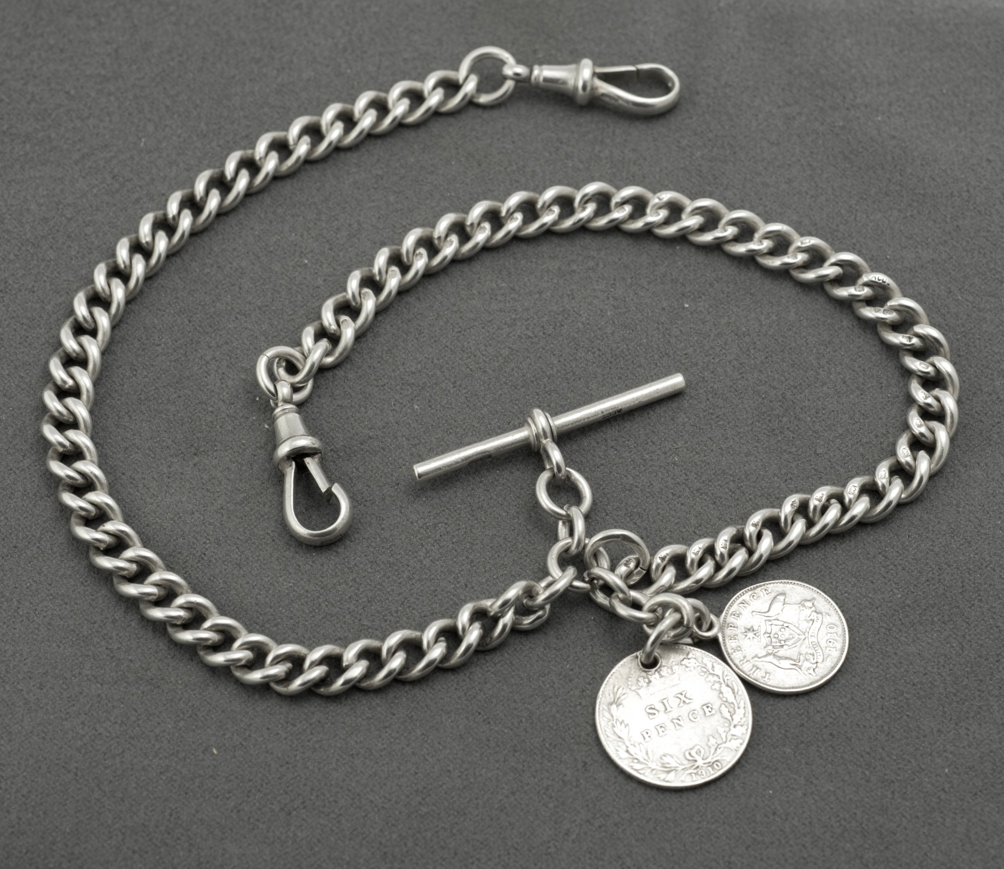Antique sterling silver double Albert chain - close up of coin obverses showing King Edward VII portrait on both British sixpence and Australian threepence dated 1910