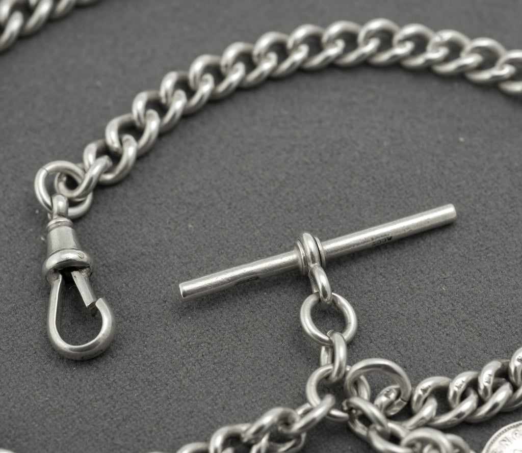Antique sterling silver double Albert chain - full length view on white background showing chain configured as necklace approximately 39cm with T-bar and coin drops