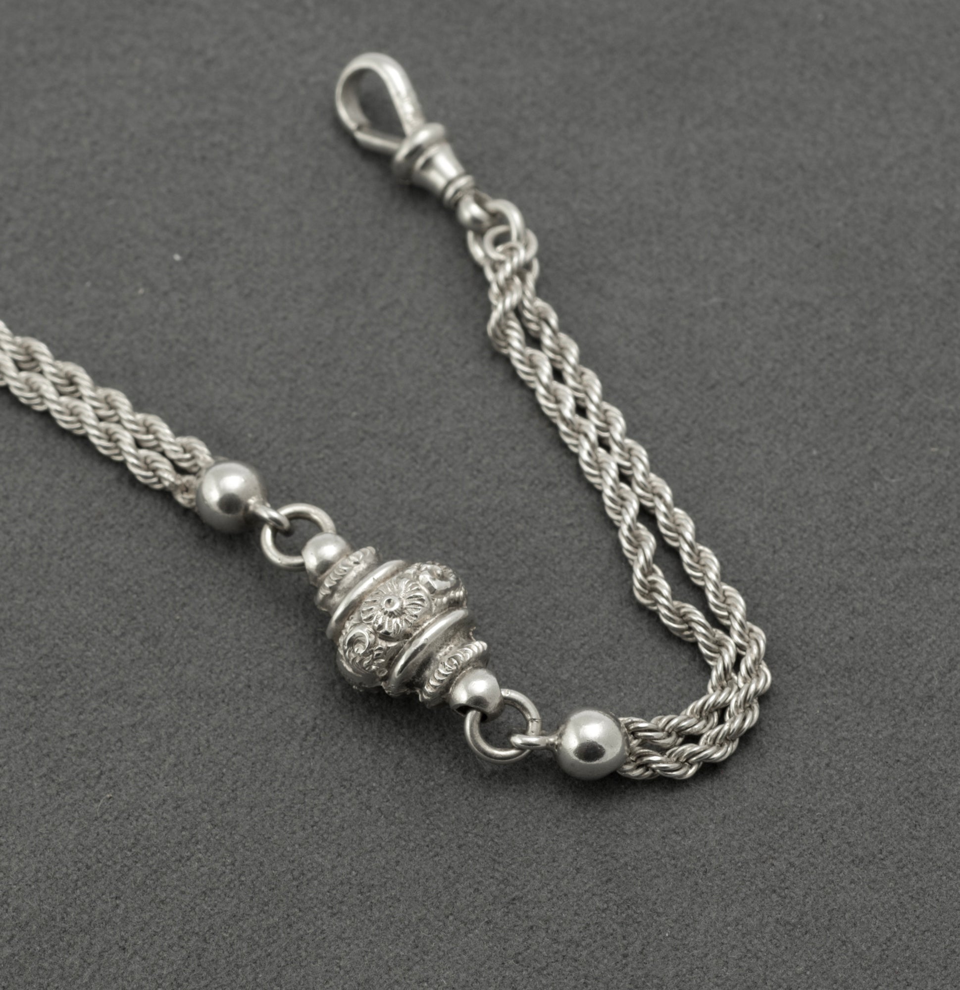 Antique Victorian sterling silver Albertina chain - close up of traditional dog clip end showing swivel fitting and multi-strand rope chain detail
