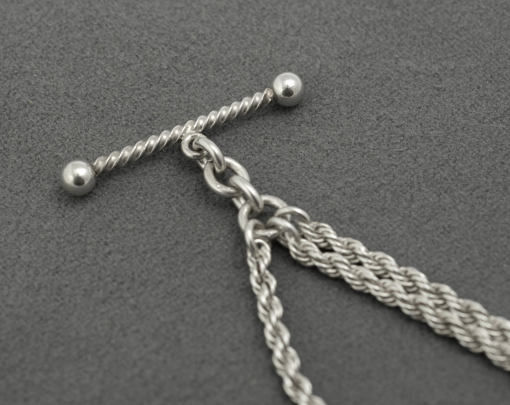 Antique Victorian sterling silver Albertina chain - full view on white background showing complete chain with twisted T-bar, heart fob suspended from rope section and dog clip end