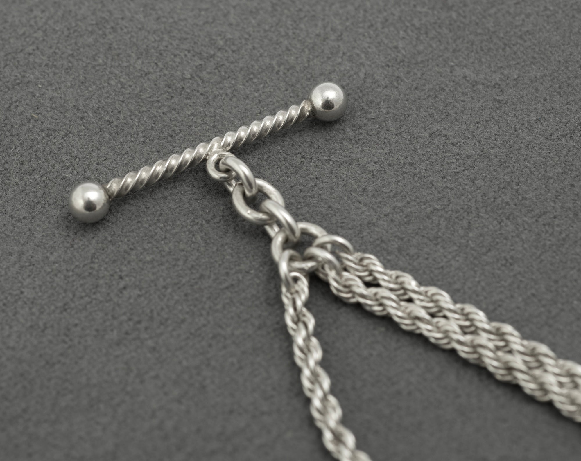 Antique Victorian sterling silver Albertina chain - full view on white background showing complete chain with twisted T-bar, heart fob suspended from rope section and dog clip end
