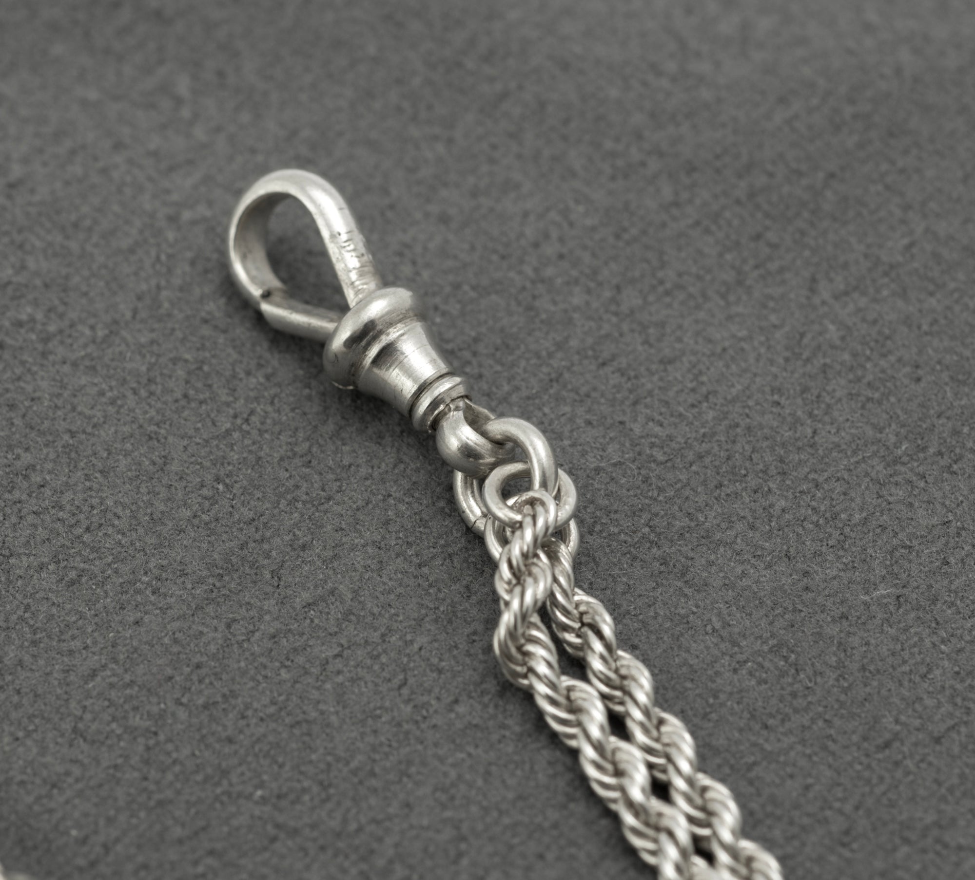 Antique Victorian sterling silver Albertina chain - full view on white background showing chain configured as bracelet with T-bar and heart fob