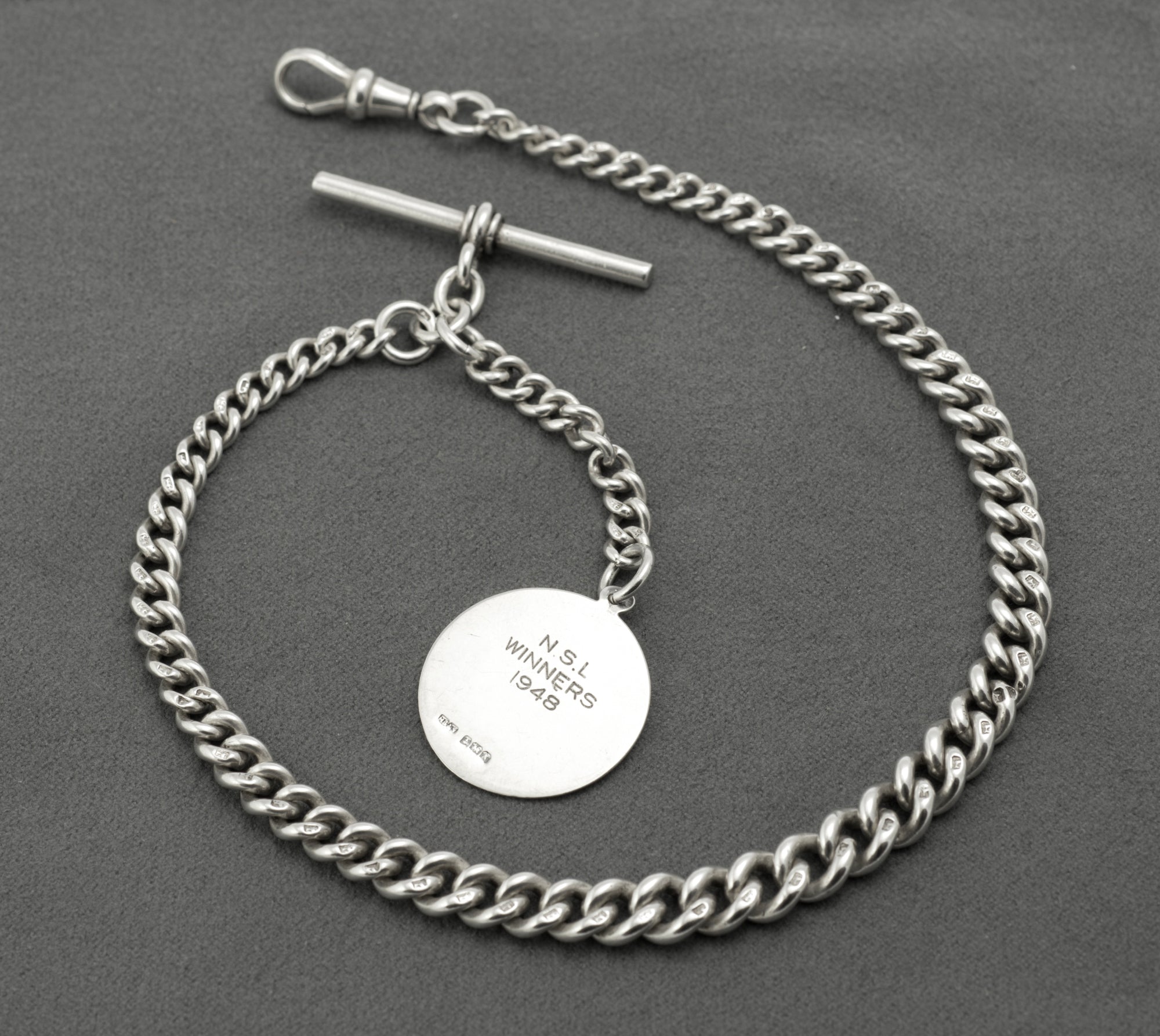 Antique Victorian sterling silver Albert chain - detail of graduated curb links showing individual lion sterling marks and widening towards centre