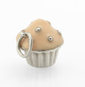 Vintage Tiffany & Co. sterling silver cupcake charm - three quarter view showing fluted silver case, peach enamel top and raised polished silver bead sprinkles with jump ring
