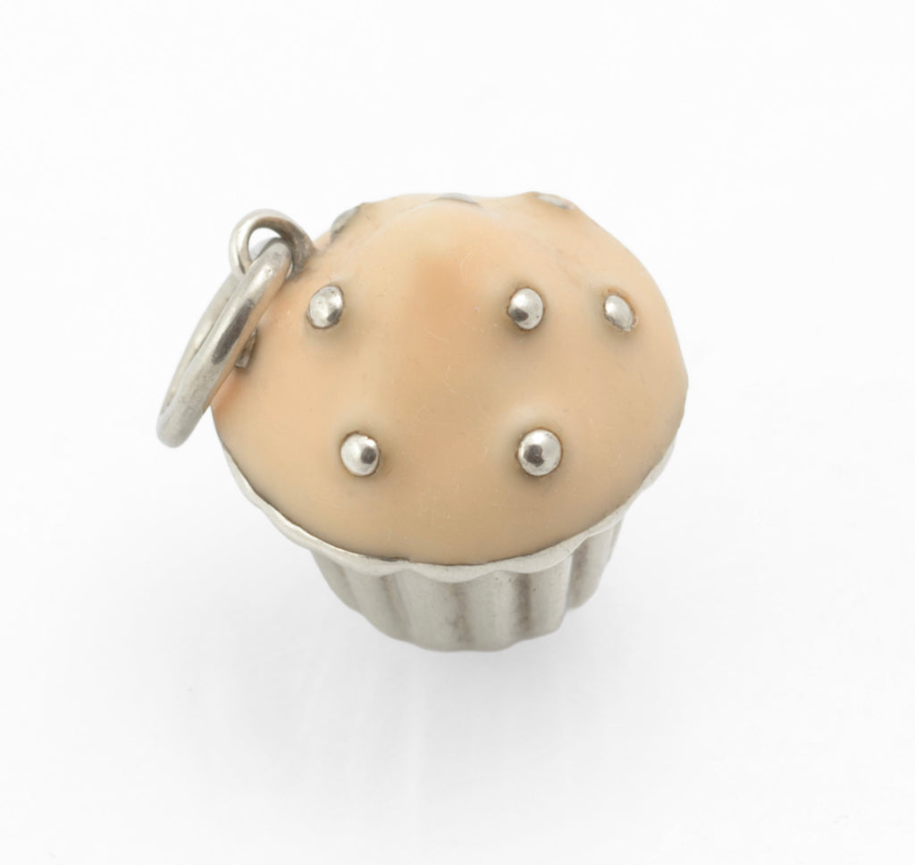 Vintage Tiffany & Co. sterling silver cupcake charm - front view showing softly rounded peach enamel icing with silver bead sprinkles on fluted silver case