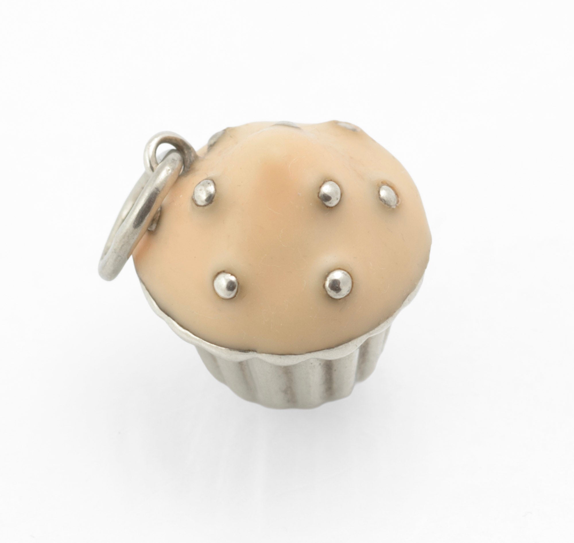 Vintage Tiffany & Co. sterling silver cupcake charm - front view showing softly rounded peach enamel icing with silver bead sprinkles on fluted silver case