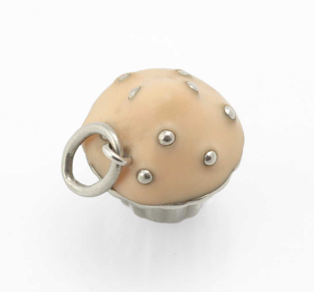 Vintage Tiffany & Co. sterling silver cupcake charm - side view showing profile of fluted case, enamel dome and jump ring attachment