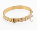 Edwardian gold metal cored buckle bangle - three quarter view showing plain polished reverse and concealed box clasp with fine-link safety chain