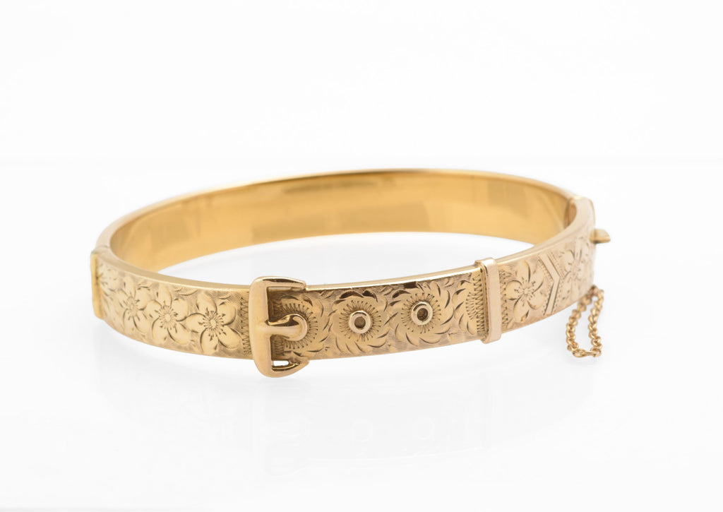 Edwardian gold metal cored buckle bangle - side view showing oval hinged form and safety chain attachment points