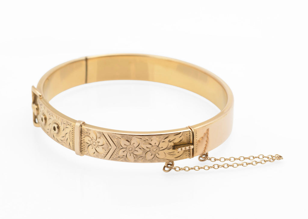 Edwardian gold metal cored buckle bangle - front view showing applied buckle top and keeper with engraved flowers and foliage on textured ground