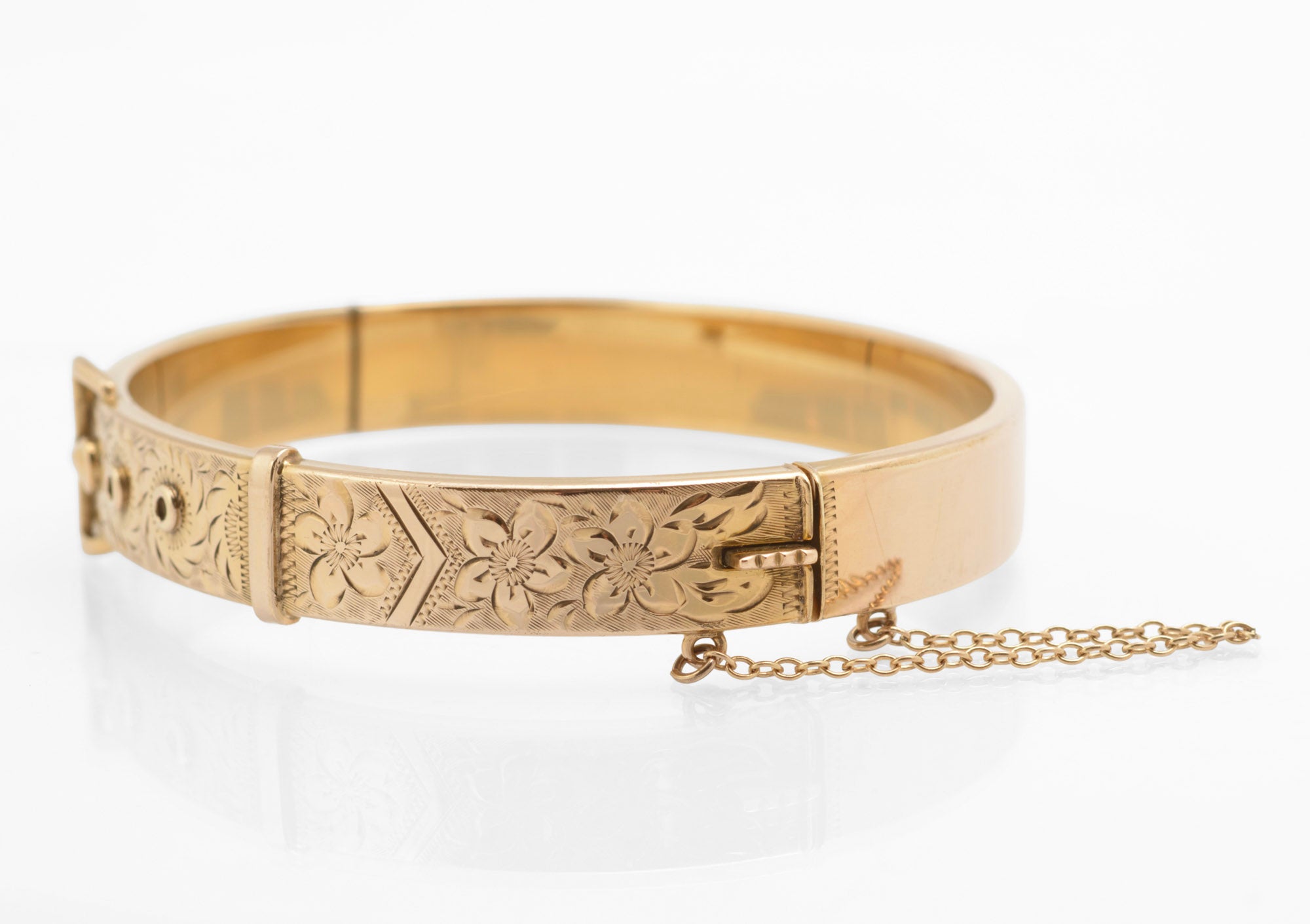 Edwardian gold metal cored buckle bangle - alternative front view showing raised circular adjustment hole details and engraved foliate decoration