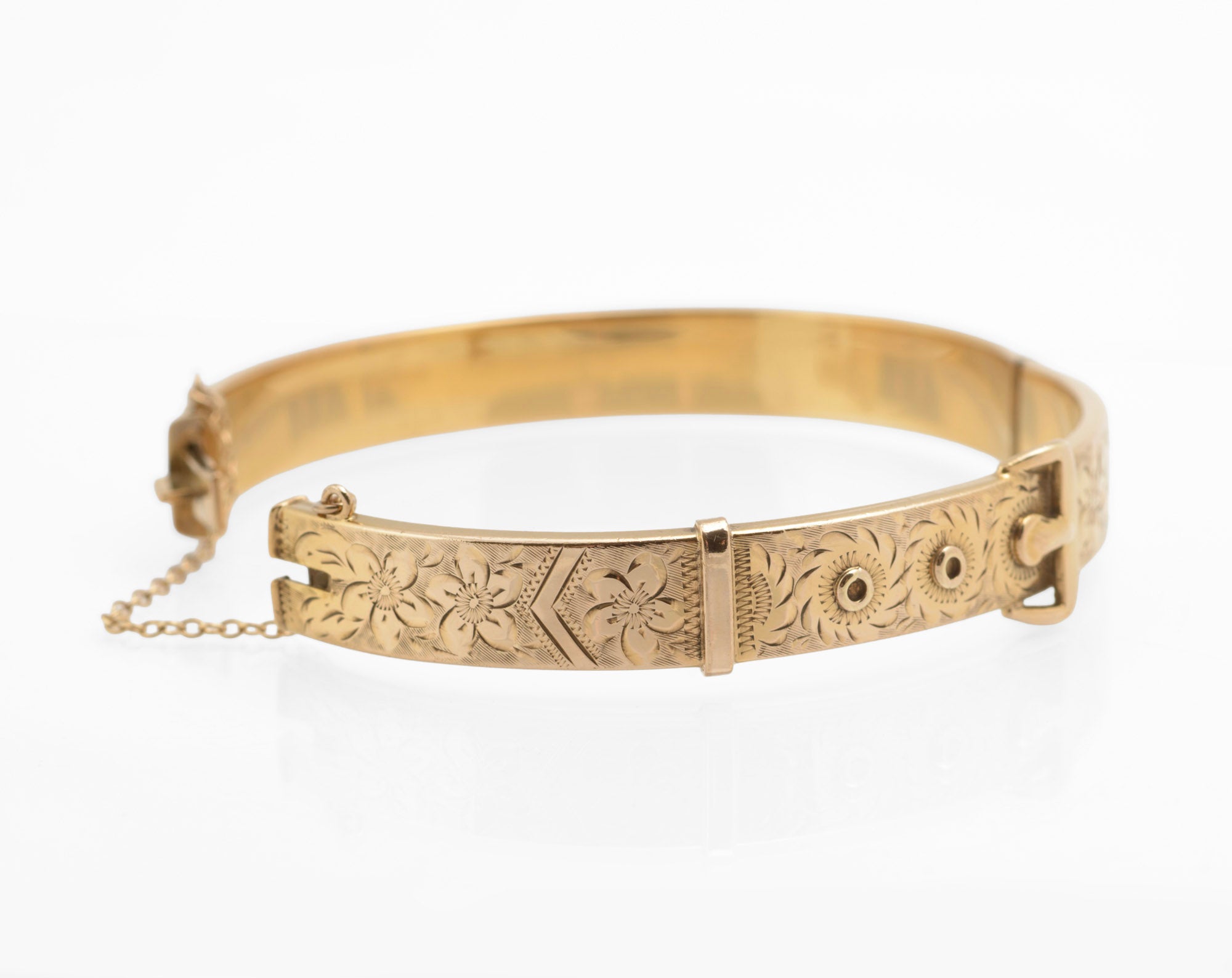 Edwardian gold metal cored buckle bangle - close up of applied buckle top showing fine engraving and raised circular hole details