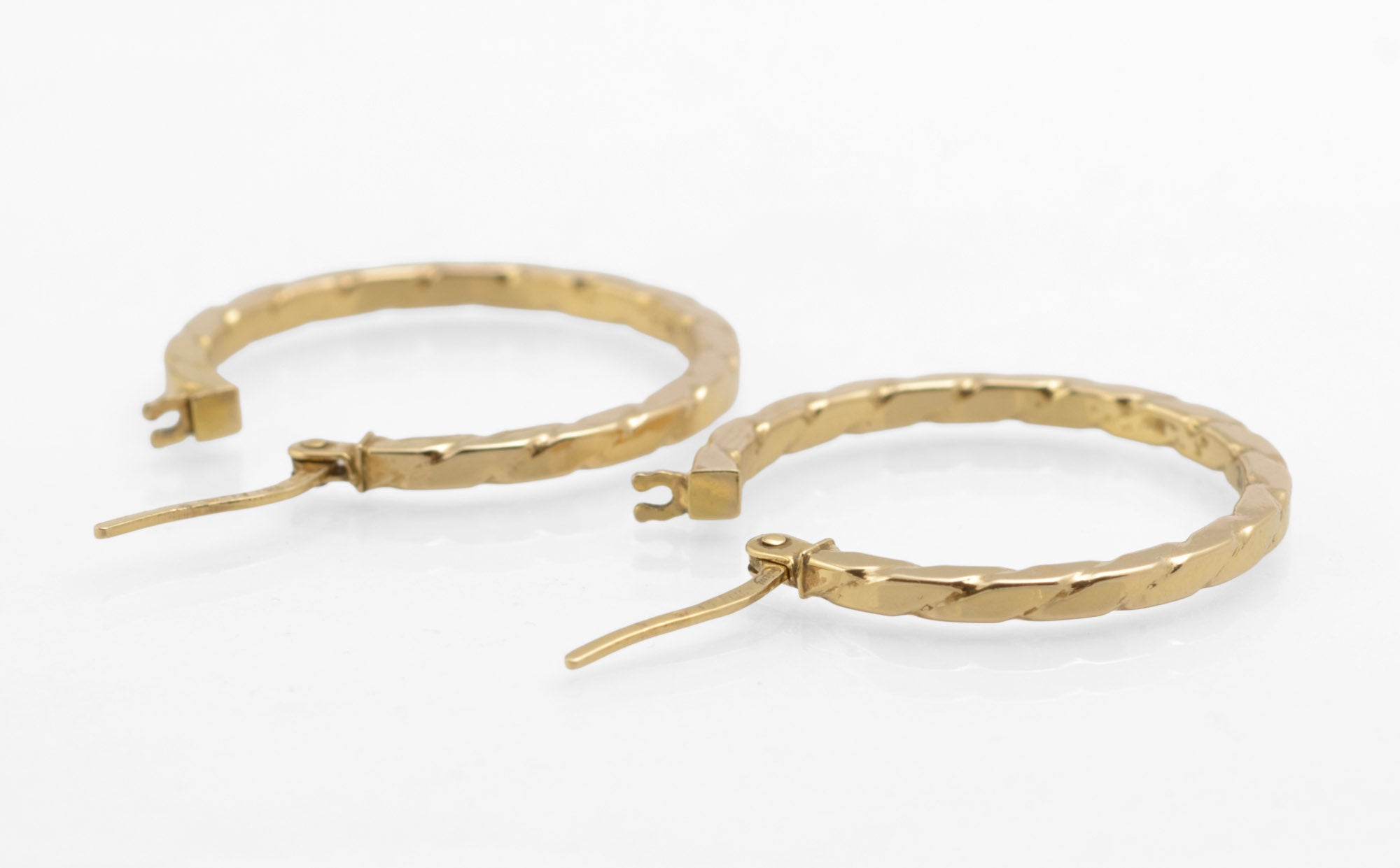 Vintage 9ct gold Unoaerre hoop earrings - front view showing both hoops closed with lever fittings secured