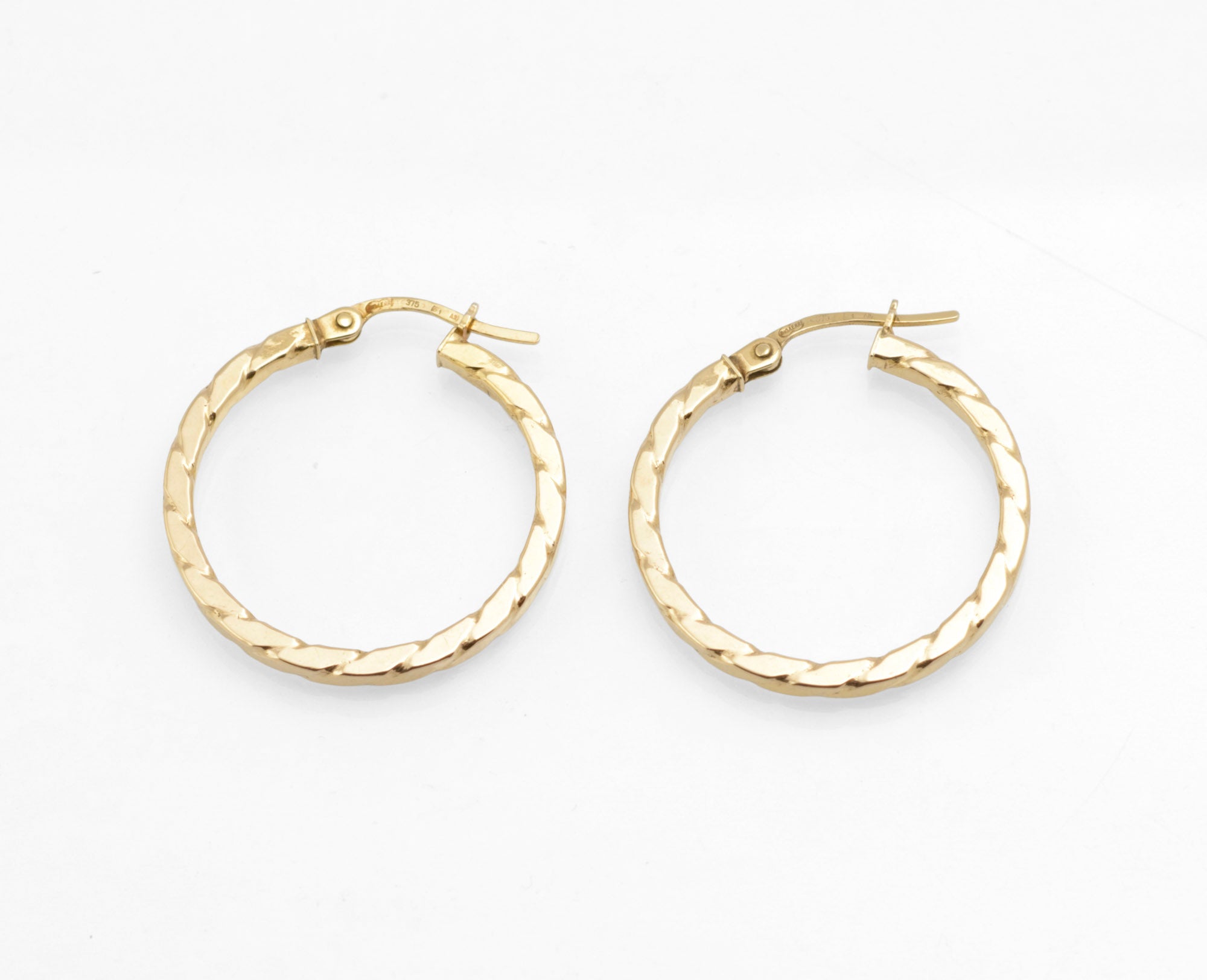 Vintage 9ct gold Unoaerre hoop earrings - close up of lever showing Birmingham international convention hallmarks confirming 9ct gold
