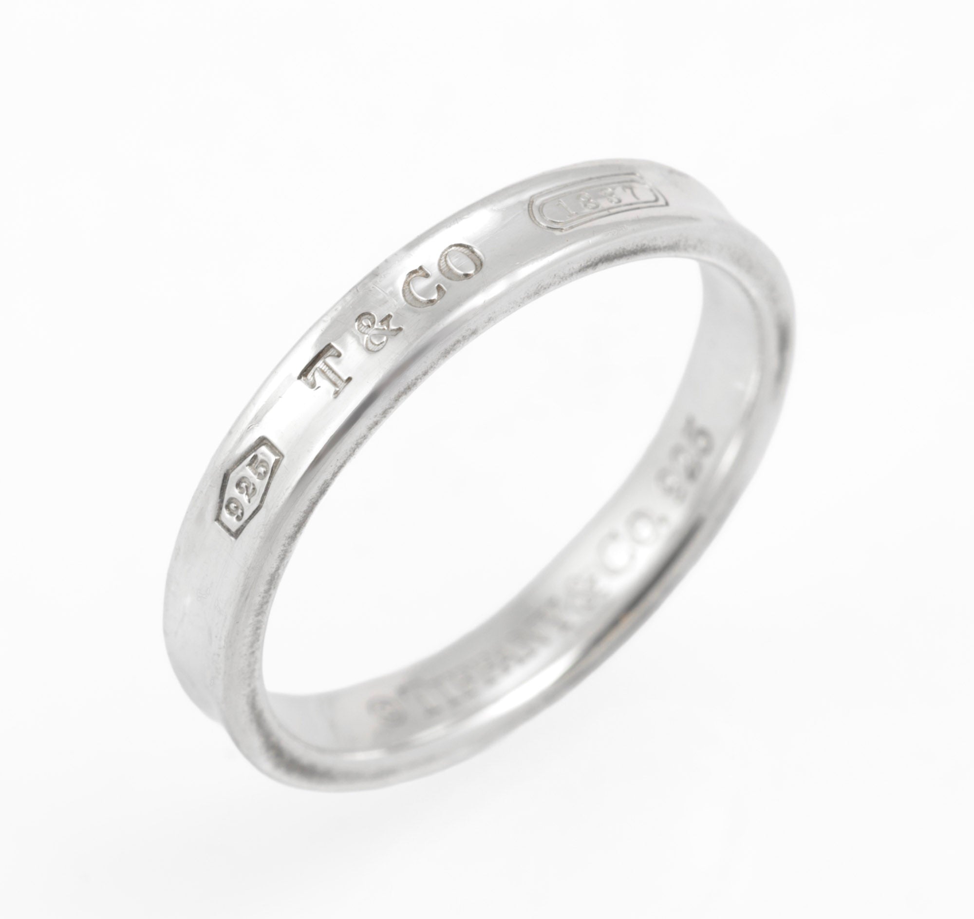Vintage Tiffany & Co. 1837 sterling silver band ring - front view on white background showing concave profile and engraved markings