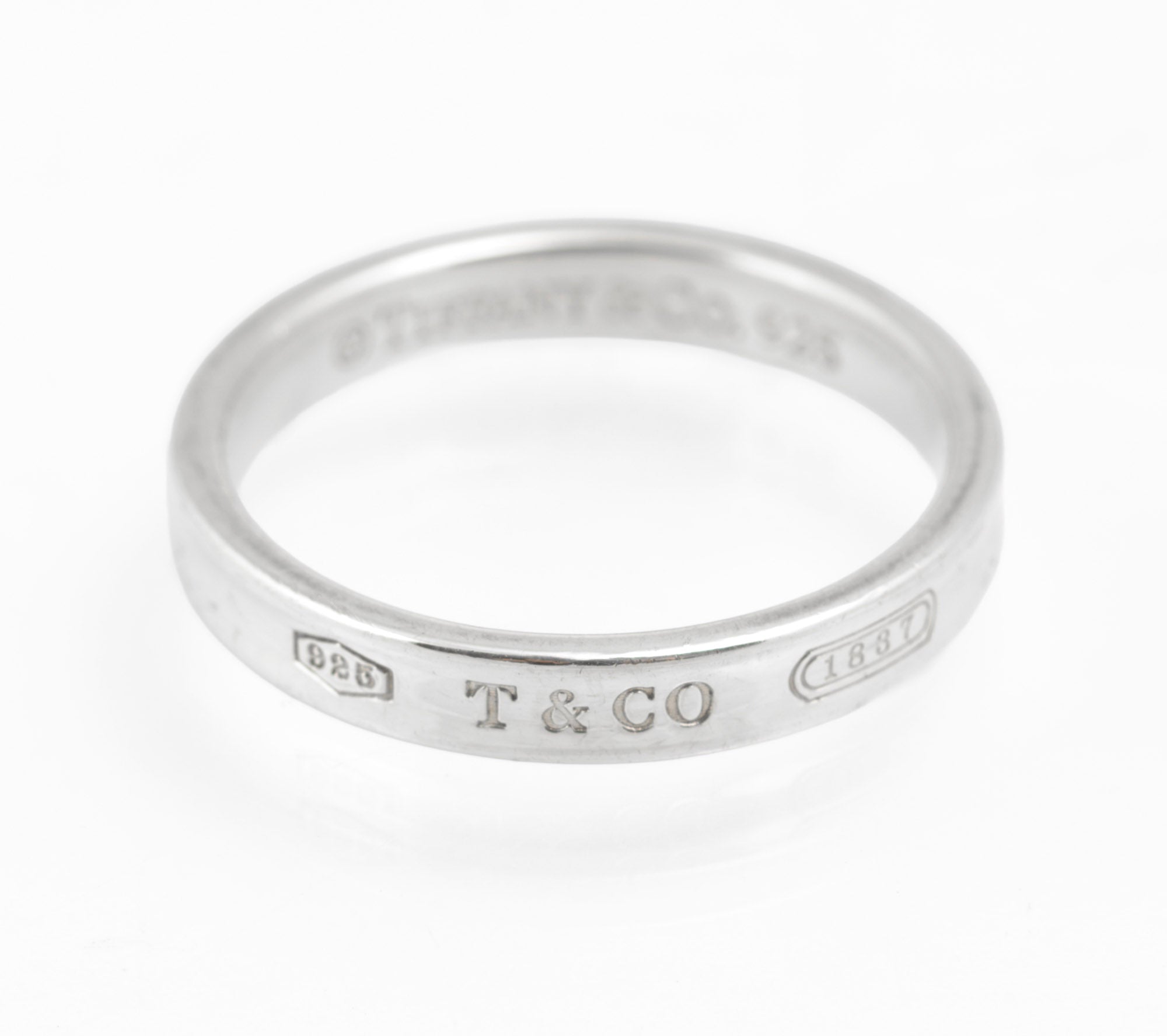 Vintage Tiffany & Co. 1837 sterling silver band ring - three-quarter view showing 925 cartouche and 1837 engraving detail