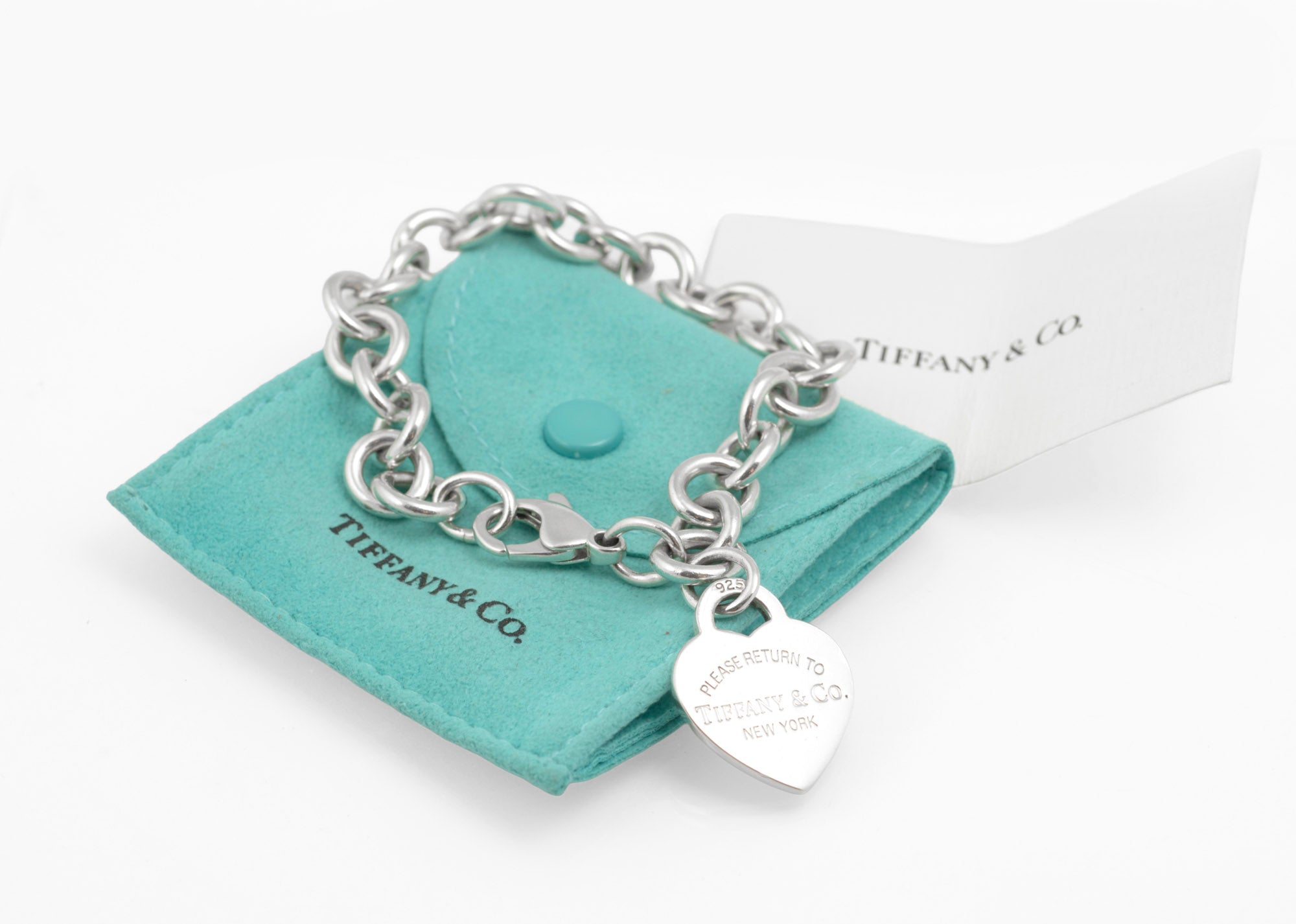 Tiffany & Co. Return to Tiffany bracelet on blue pouch - three-quarter view showing round link chain and heart tag