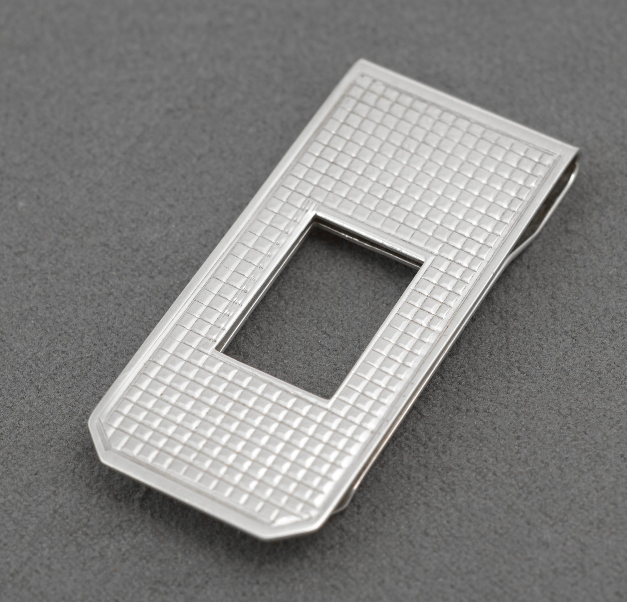 Vintage sterling silver money clip - front view showing square engine-turned grid decoration and rectangular central aperture