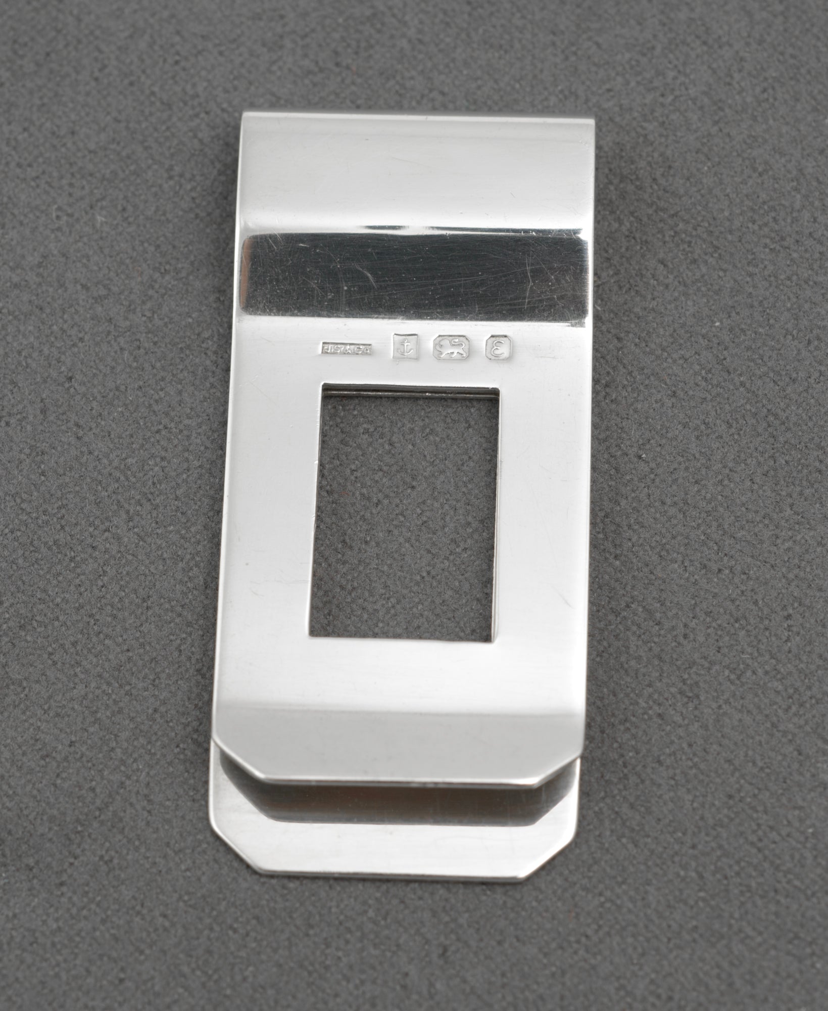 Vintage sterling silver money clip - angled reverse view on white background showing hallmarks and folded spring construction