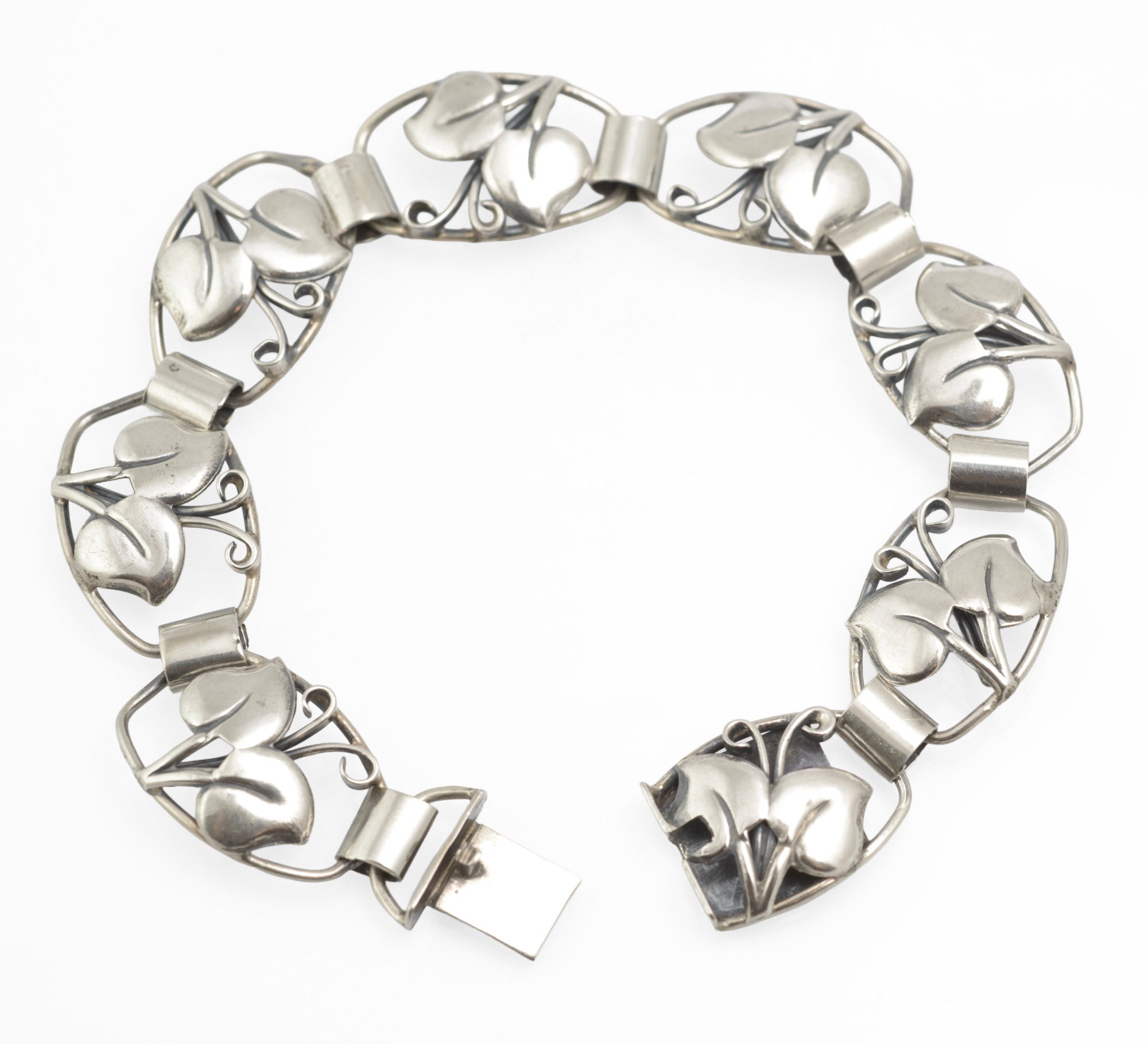 Vintage Danish 830 silver bracelet by Arne Henning Petersen - close-up of foliate openwork panels showing raised leaves and curling tendrils