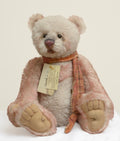 A large seated Charlie Bears Isabelle Collection bear named Solitaire, dressed in a woven scarf trimmed with a column of vintage-style buttons, limited to 500 pieces worldwide.