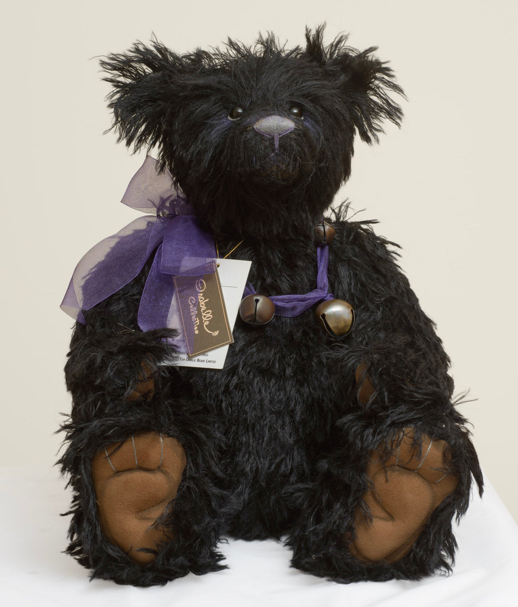 Charlie Bears Indigo - Isabelle Collection - full front view showing deep black long-pile mohair with purple organza ribbon bow and three bronze bells