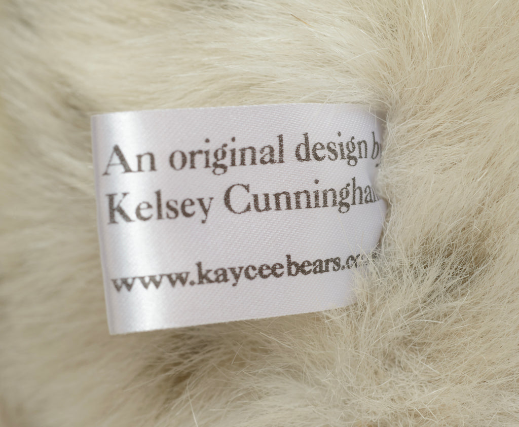 Kaycee Bears Domino - Kelsey Cunningham - detail of large silver-tone dragonfly pendant with pierced wing detail on copper organza ribbon
