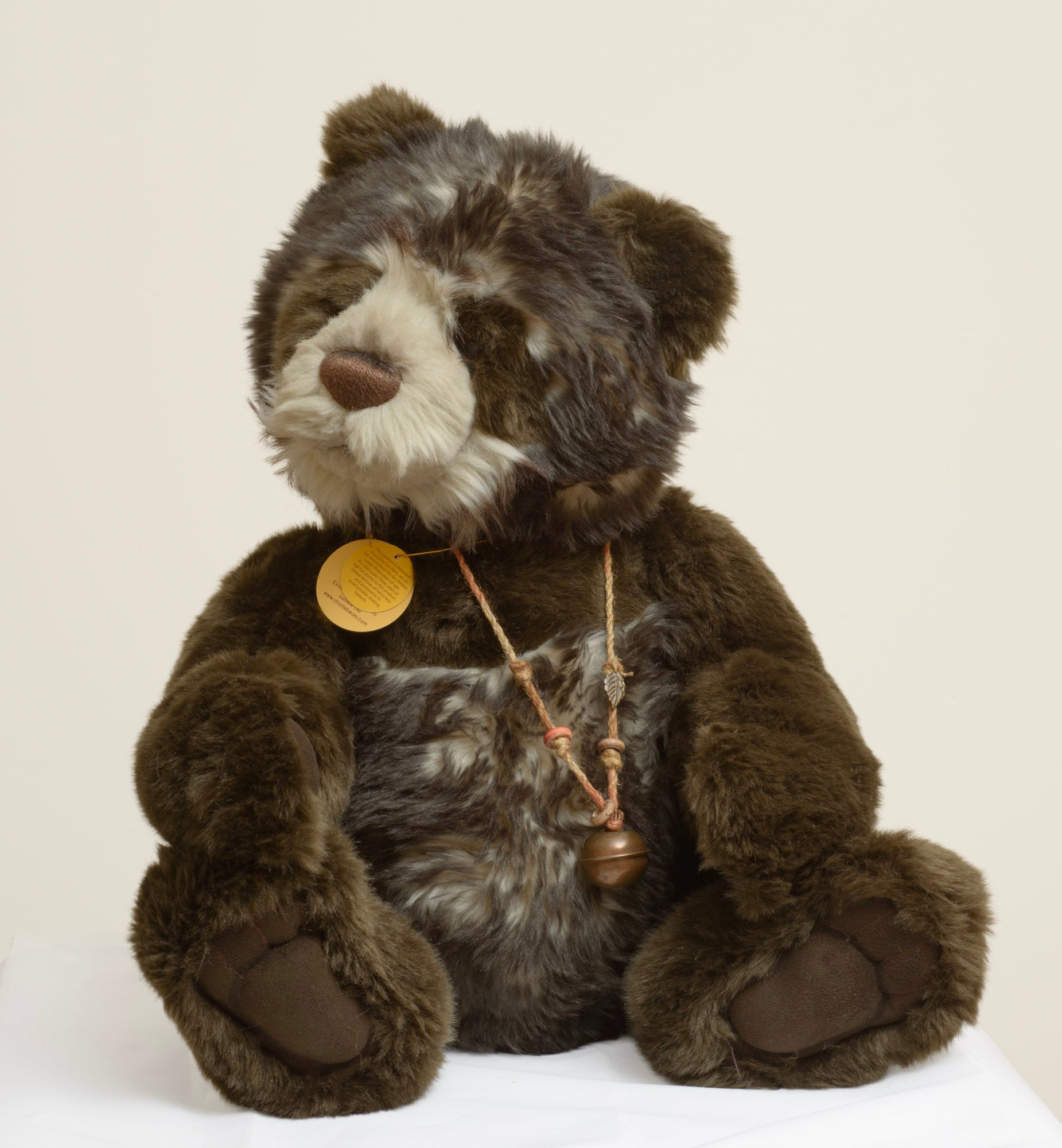 Charlie Bears Breeny - Isabelle Collection - rear view showing dark chocolate tipped plush coat and Charlie Bears woven label in cream on dark plum