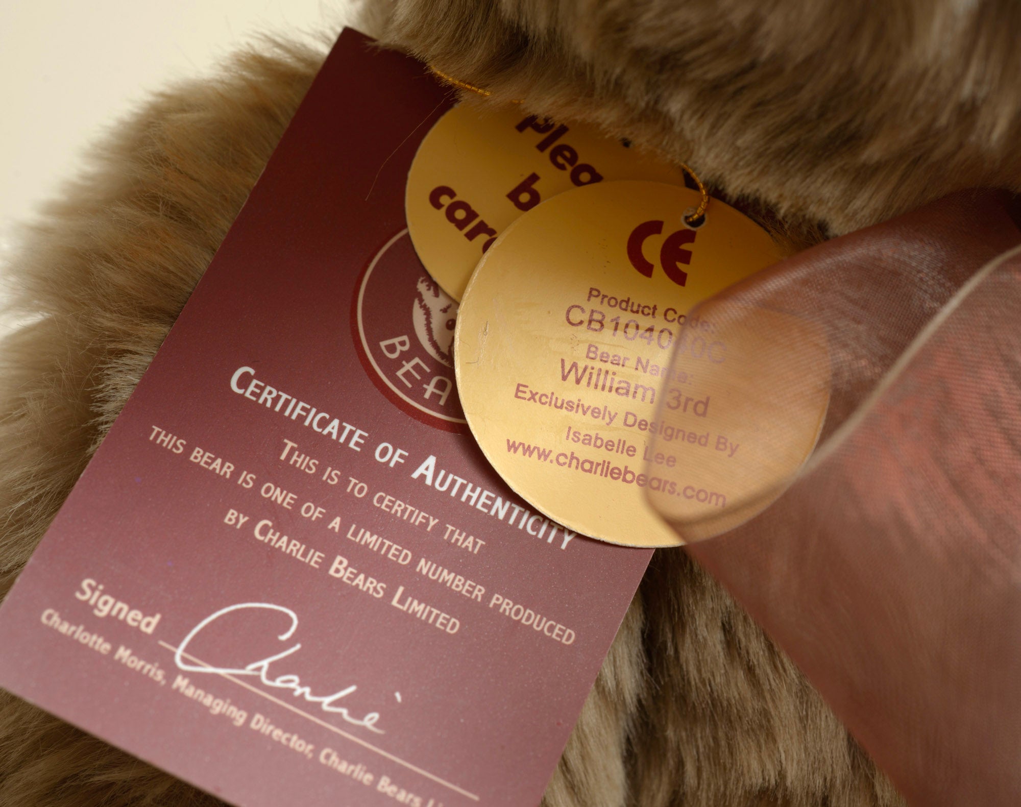 Charlie Bears William III - rear view showing sandy taupe tipped plush coat and Charlie Bears woven label in cream on dark plum